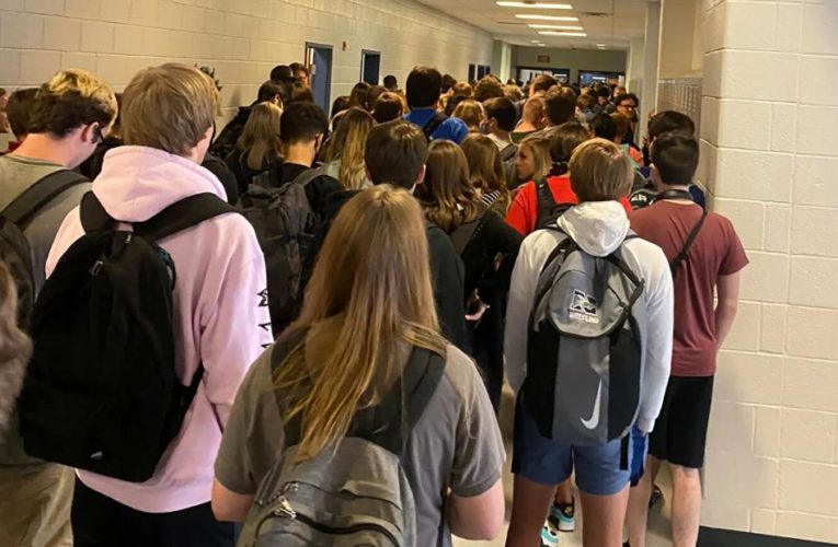 A high school, where a photo of a crowded hallway went viral, will start the week with virtual learning after at least nine people tested positive for Covid-19