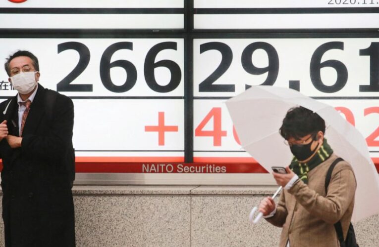Stocks mostly fall, even as tech gains push Nasdaq to record