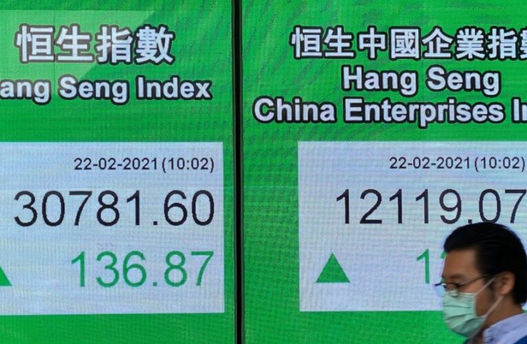 Global shares mostly lower as investors wary over stimulus