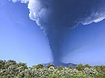 Locals sweep up volcanic rubble after fresh Mount Etna eruption covers their town with debris 