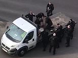 Police officers surround suspect on back of flatbed truck before Tasering him after London stabbing